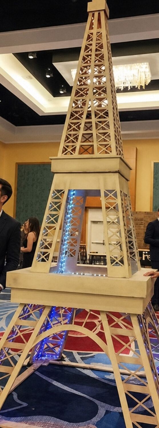 Giant wooden Eiffel Tower prop illuminated with lights