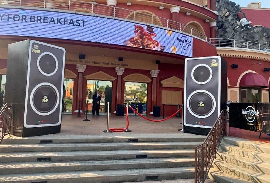 Pair of oversized loudspeakers flanking an entry