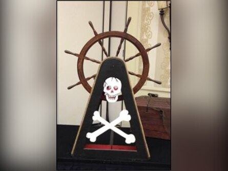 Pirate ship's wheel with skull and crossbones