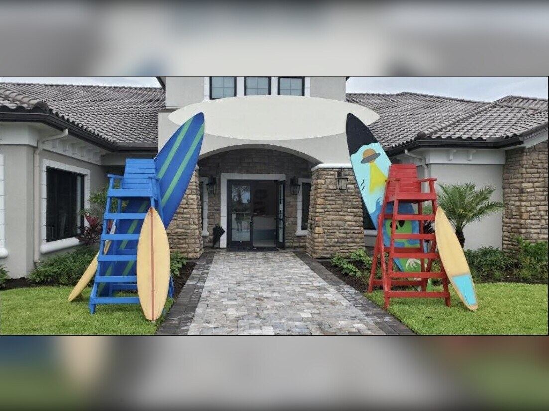 Surfboard entrance decor flanking a walkway